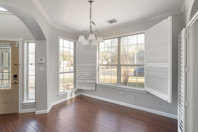 8613 Columbia Falls Dr, Round Rock, TX 78681 - entrance foyer with arched walkways, a chandelier, dark wood-style floors, and crown molding