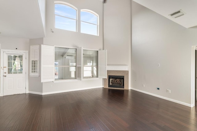 8613 Columbia Falls Dr, Round Rock, TX 78681 - unfurnished living room featuring high vaulted ceiling, healthy amount of natural light, dark wood finished floors, and a fireplace