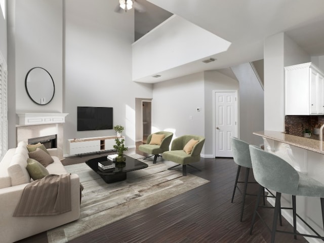 8613 Columbia Falls Dr, Round Rock, TX 78681 - living area with dark wood finished floors, a ceiling fan, a towering ceiling, and a premium fireplace