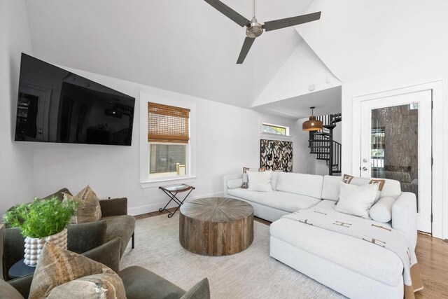 1802 Eva St, Austin, TX 78704 - living room with wood finished floors, stairway, ceiling fan, baseboards, and high vaulted ceiling