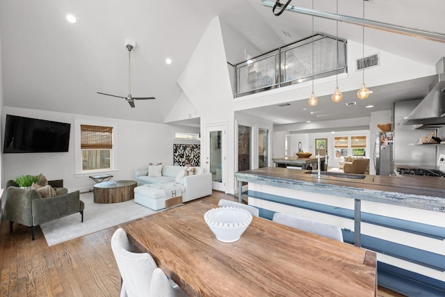 1802 Eva St, Austin, TX 78704 - dining space with wood finished floors, high vaulted ceiling, a ceiling fan, and recessed lighting
