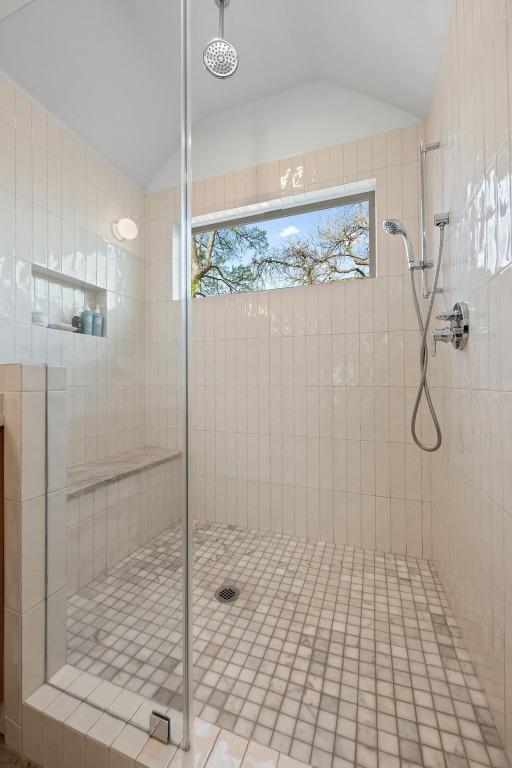 1802 Eva St, Austin, TX 78704 - bathroom featuring vaulted ceiling and a tile shower