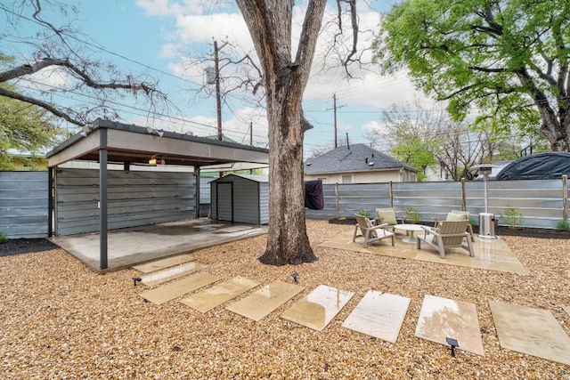 1802 Eva St, Austin, TX 78704 - view of yard with a storage unit, an outbuilding, a patio, fence, and a detached carport