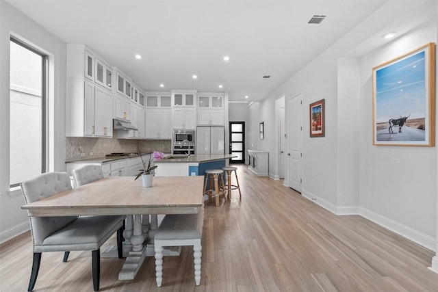 236 Diamondback Dr, Georgetown, TX 78628 - dining area with light wood-type flooring, baseboards, and recessed lighting