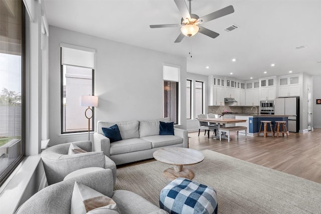 236 Diamondback Dr, Georgetown, TX 78628 - living area featuring healthy amount of natural light, recessed lighting, a ceiling fan, and light wood finished floors