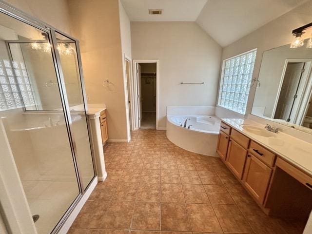 full bath featuring a shower stall, lofted ceiling, vanity, and a garden tub