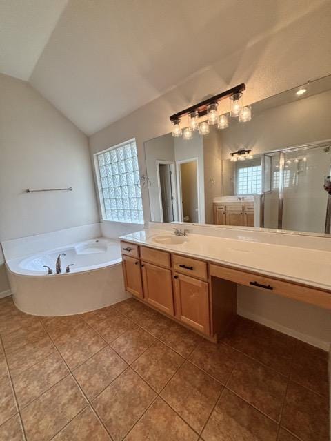 bathroom with vanity, vaulted ceiling, tile patterned floors, a stall shower, and a bath