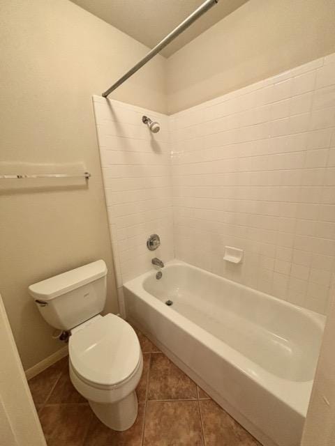 bathroom featuring shower / bathing tub combination, toilet, and tile patterned flooring