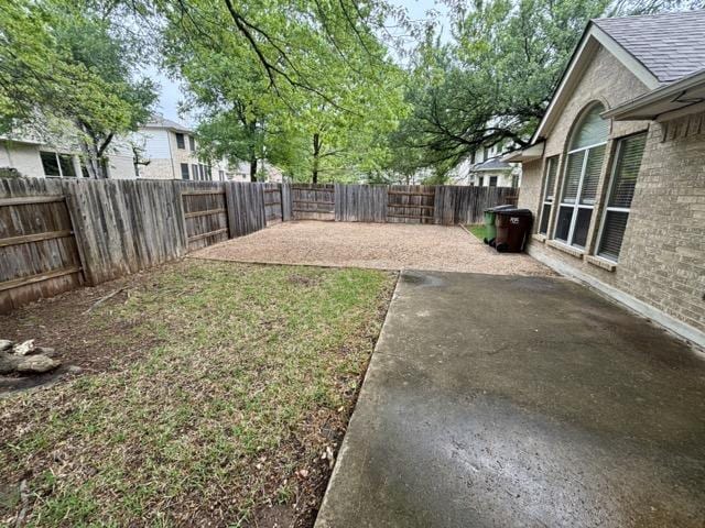 view of yard with a fenced backyard and a patio