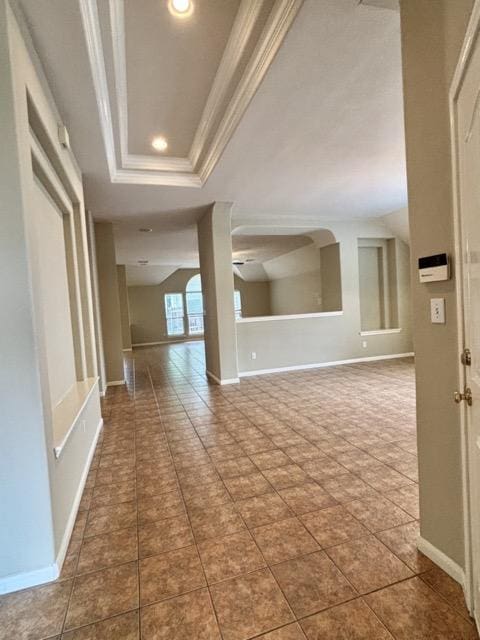 tiled spare room with baseboards, a tray ceiling, recessed lighting, and ornamental molding