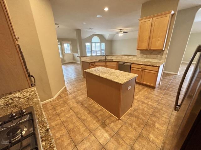 kitchen with decorative backsplash, stainless steel dishwasher, light stone counters, ceiling fan, and a peninsula