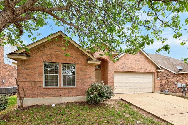 2832 Mission Tejas Dr, Pflugerville, TX 78660 - view of front of house featuring an attached garage, driveway, and brick siding
