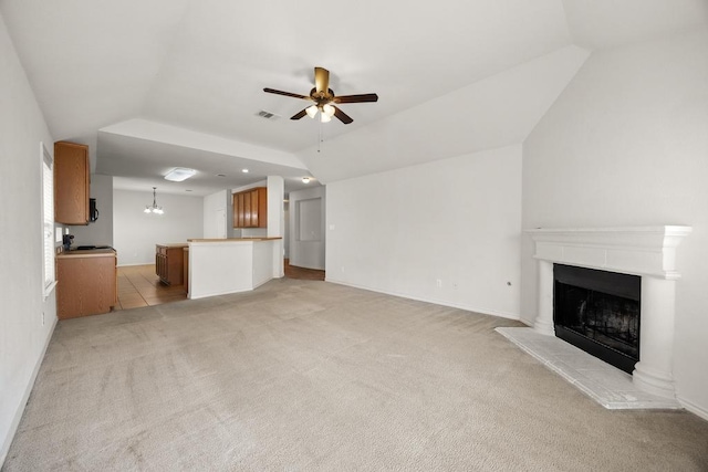 2832 Mission Tejas Dr, Pflugerville, TX 78660 - unfurnished living room featuring ceiling fan, lofted ceiling, light colored carpet, a fireplace with raised hearth, and baseboards