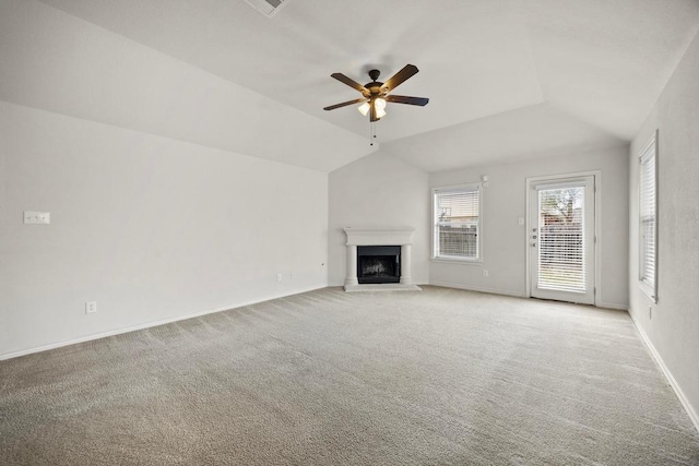 2832 Mission Tejas Dr, Pflugerville, TX 78660 - unfurnished living room with ceiling fan, a fireplace with raised hearth, light carpet, vaulted ceiling, and baseboards