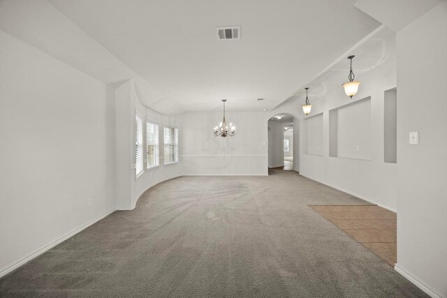 2832 Mission Tejas Dr, Pflugerville, TX 78660 - unfurnished living room featuring arched walkways, carpet flooring, a chandelier, and baseboards