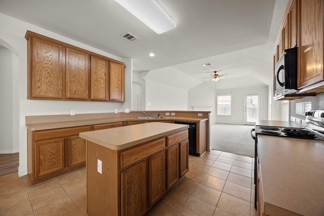 2832 Mission Tejas Dr, Pflugerville, TX 78660 - kitchen featuring stainless steel appliances, a ceiling fan, a sink, brown cabinetry, and light tile patterned floors