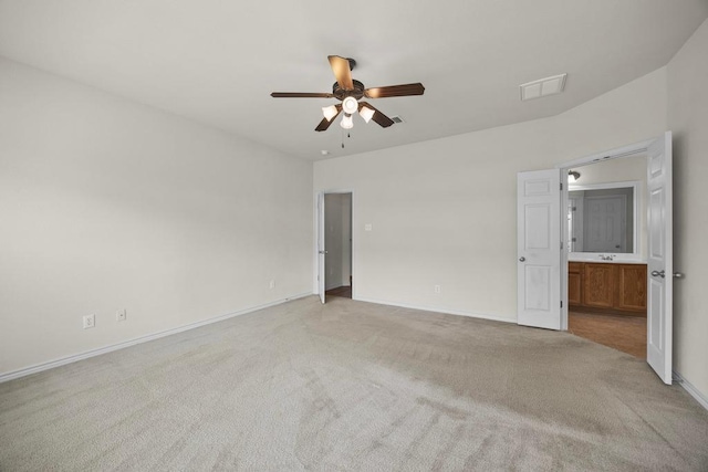 2832 Mission Tejas Dr, Pflugerville, TX 78660 - unfurnished bedroom with light colored carpet, baseboards, ensuite bathroom, and ceiling fan
