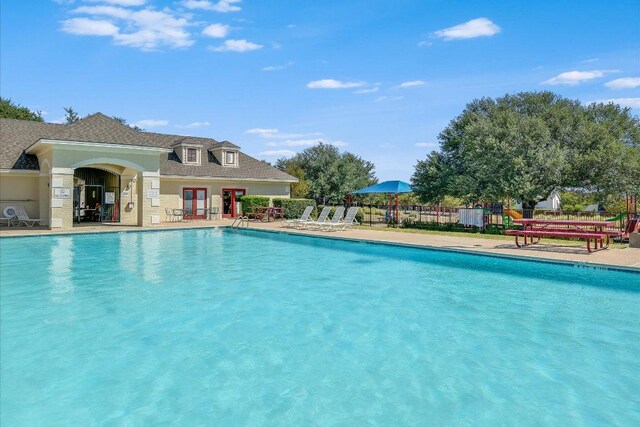 pool featuring fence and a patio