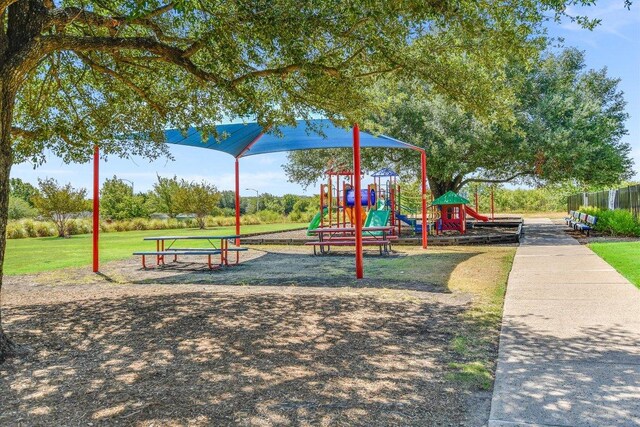 community jungle gym featuring a yard