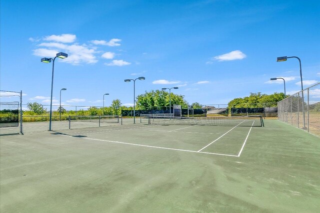 view of tennis court with fence