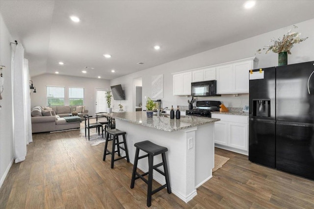 249 Calgary Ln, San Marcos, TX 78666 - kitchen featuring black appliances, recessed lighting, white cabinetry, dark wood-style floors, and light stone countertops