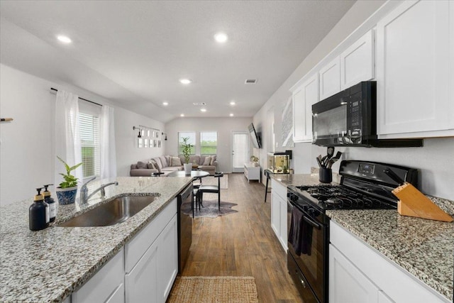 249 Calgary Ln, San Marcos, TX 78666 - kitchen with black appliances, a sink, dark wood-style floors, recessed lighting, and white cabinets