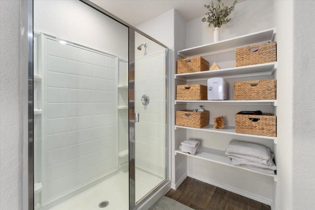 249 Calgary Ln, San Marcos, TX 78666 - bathroom featuring wood finished floors and a stall shower