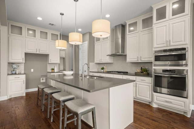 6009 Empresa Dr, Austin, TX 78738 - kitchen with wall chimney exhaust hood, a sink, stainless steel double oven, dark countertops, and backsplash