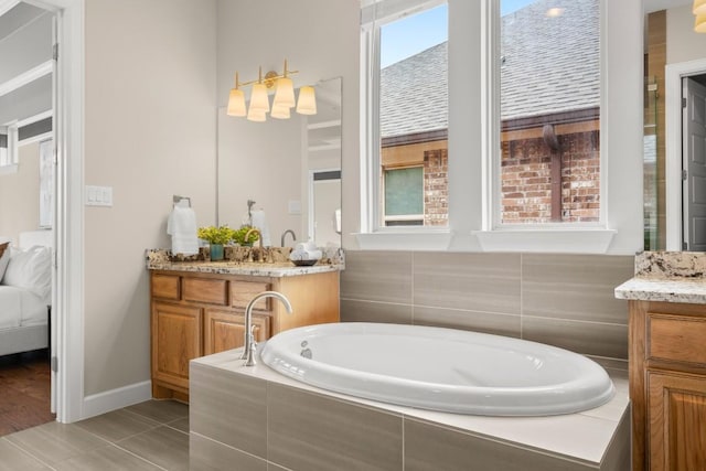6009 Empresa Dr, Austin, TX 78738 - bathroom featuring vanity, a garden tub, connected bathroom, and baseboards