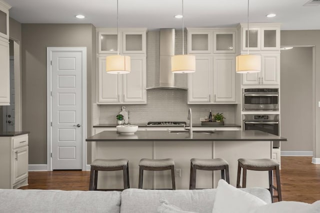 6009 Empresa Dr, Austin, TX 78738 - kitchen featuring a sink, wall chimney exhaust hood, dark countertops, and recessed lighting