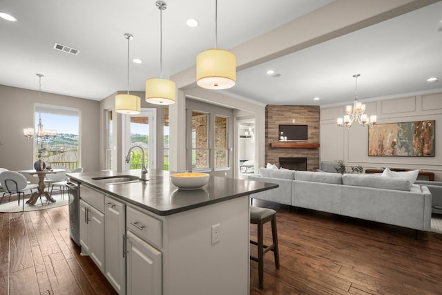 6009 Empresa Dr, Austin, TX 78738 - kitchen featuring a sink, a chandelier, dark countertops, open floor plan, and dark wood-style flooring