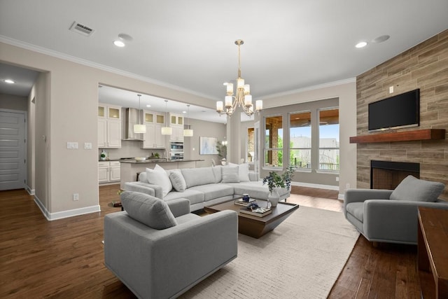 6009 Empresa Dr, Austin, TX 78738 - living area featuring ornamental molding, dark wood-style flooring, a chandelier, baseboards, and recessed lighting
