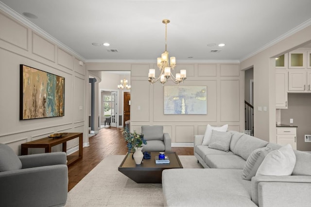 6009 Empresa Dr, Austin, TX 78738 - living area featuring a decorative wall, a chandelier, ornamental molding, wood finished floors, and stairs