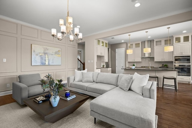 6009 Empresa Dr, Austin, TX 78738 - living area with ornamental molding, recessed lighting, a chandelier, dark wood finished floors, and a decorative wall