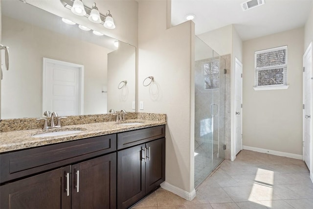 7709 Menchaca Rd Unit 35, Austin, TX 78745 - full bath with a stall shower, double vanity, and tile patterned flooring