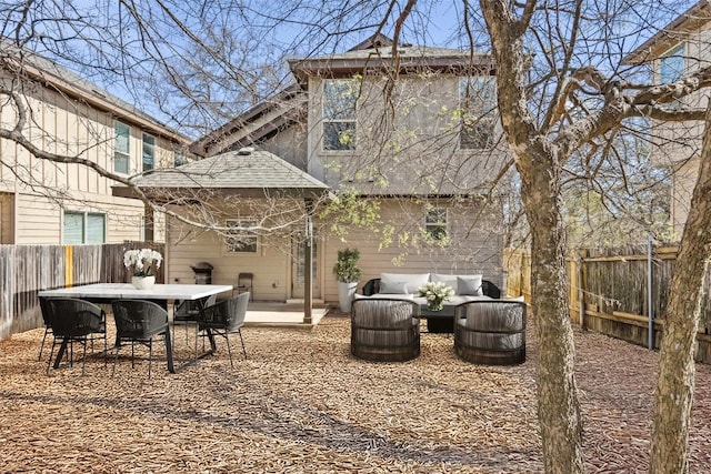 7709 Menchaca Rd Unit 35, Austin, TX 78745 - rear view of house featuring a fenced backyard, an outdoor living space, roof with shingles, outdoor dining space, and a patio