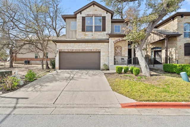 7709 Menchaca Rd Unit 35, Austin, TX 78745 - view of front of home with stone siding, a garage, driveway, and a front yard
