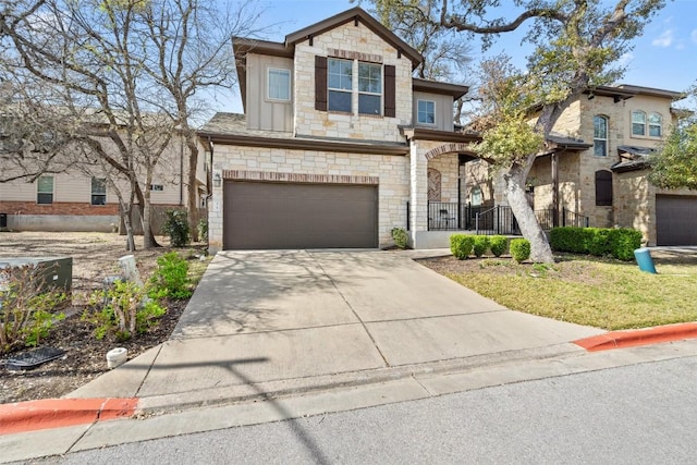 7709 Menchaca Rd Unit 35, Austin, TX 78745 - view of front of home with stone siding, covered porch, an attached garage, concrete driveway, and board and batten siding