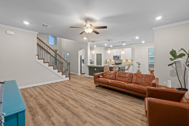 1806 Ashburn Dr, Temple, TX 76502 - living area featuring crown molding, ceiling fan, recessed lighting, arched walkways, and light wood finished floors
