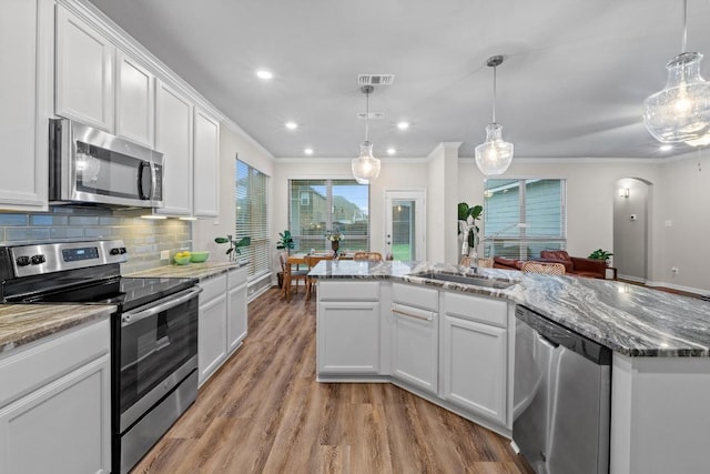 1806 Ashburn Dr, Temple, TX 76502 - kitchen with stainless steel appliances, ornamental molding, light wood finished floors, white cabinets, and stone countertops