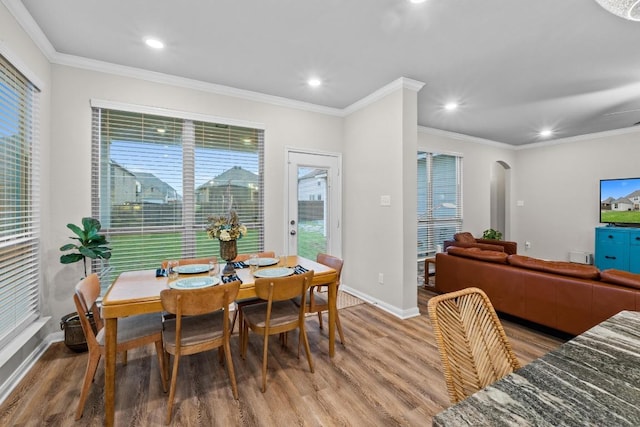1806 Ashburn Dr, Temple, TX 76502 - dining space featuring arched walkways, light wood-style floors, recessed lighting, ornamental molding, and plenty of natural light