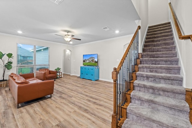 1806 Ashburn Dr, Temple, TX 76502 - living area with light wood finished floors, crown molding, stairs, arched walkways, and a ceiling fan