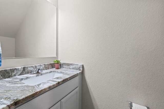 1806 Ashburn Dr, Temple, TX 76502 - bathroom with vanity and lofted ceiling