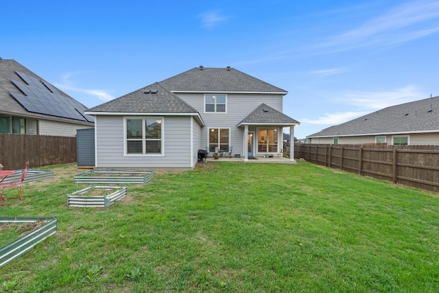 1806 Ashburn Dr, Temple, TX 76502 - back of property with a garden, a fenced backyard, a shingled roof, and a patio