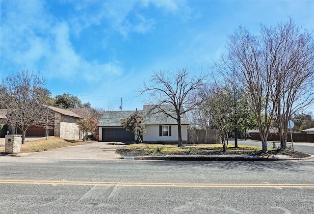 11501 Oak Knoll Dr, Austin, TX 78759 - view of front facade with a garage, asphalt driveway, and stone siding