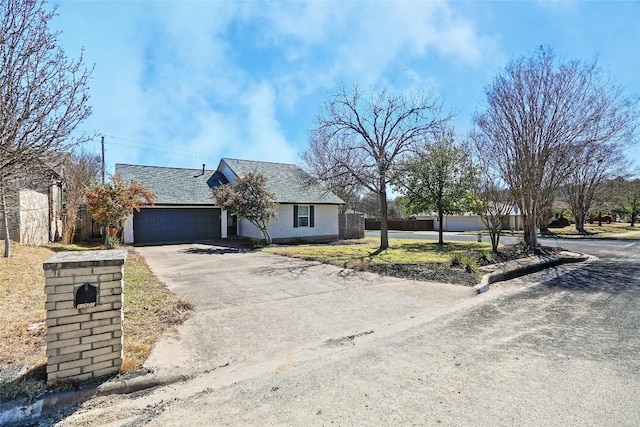 11501 Oak Knoll Dr, Austin, TX 78759 - view of front of house with asphalt driveway, an attached garage, and a front lawn