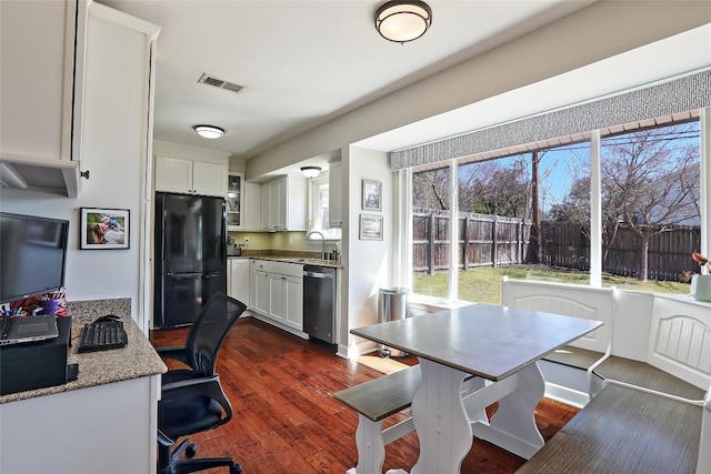 11501 Oak Knoll Dr, Austin, TX 78759 - kitchen with freestanding refrigerator, dishwasher, white cabinets, and dark wood-style floors