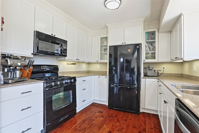 11501 Oak Knoll Dr, Austin, TX 78759 - kitchen featuring black appliances, dark wood-style flooring, white cabinetry, glass insert cabinets, and light stone counters