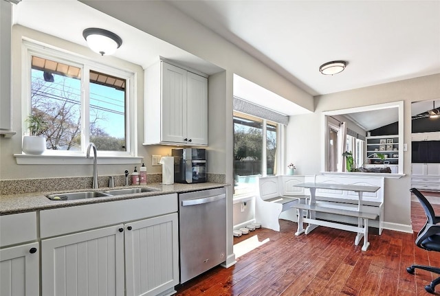 11501 Oak Knoll Dr, Austin, TX 78759 - kitchen featuring stainless steel dishwasher, dark wood-type flooring, lofted ceiling, and light stone countertops