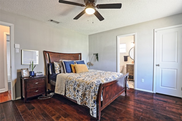 11501 Oak Knoll Dr, Austin, TX 78759 - bedroom with dark wood-type flooring, a textured ceiling, ceiling fan, and connected bathroom